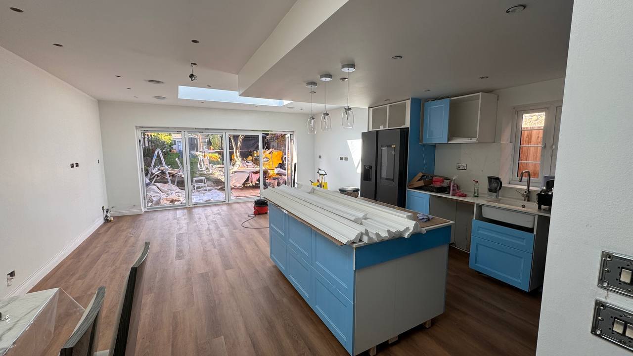MALCON rear extension in Chelmsford during final fit-out: open-plan kitchen with island, roof light and bi-fold doors to the garden